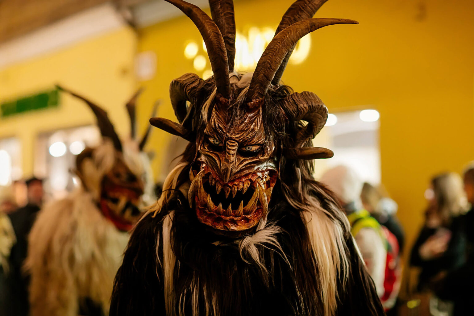 People in scary fur costumes and masks with hornes