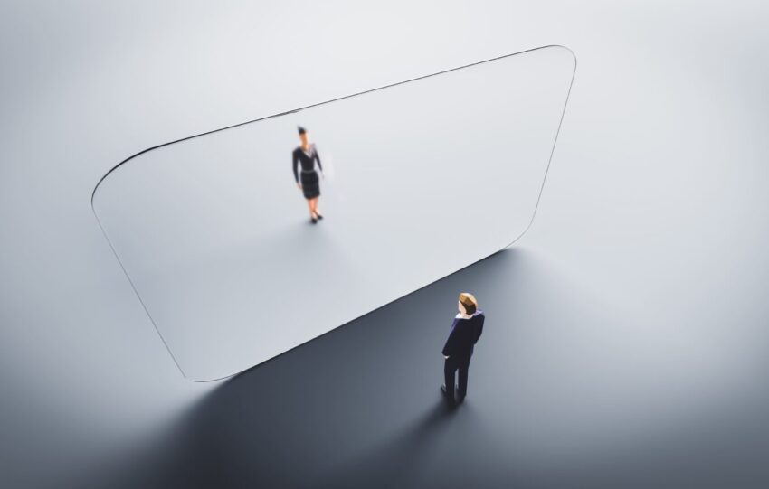 Man and woman meet on both sides of glass wall