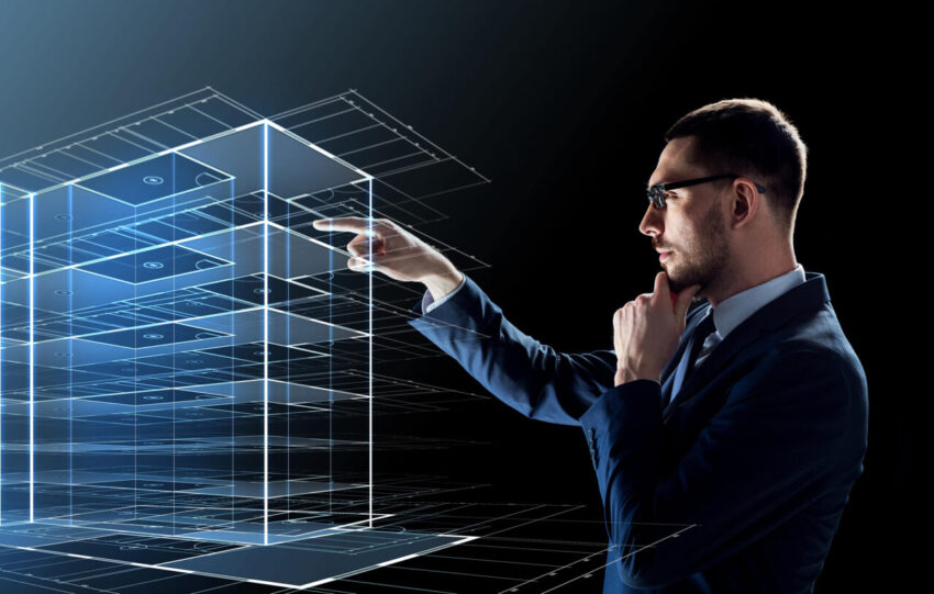businessman in glasses with virtual construction hologram