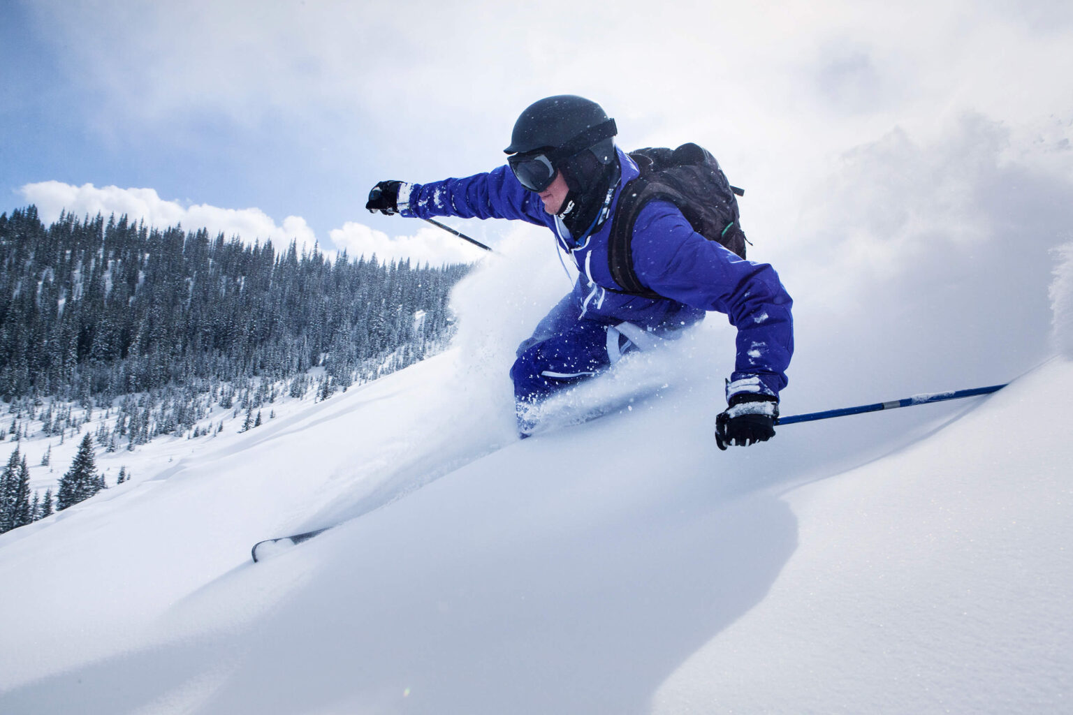 skier on snow covered mountain against sky